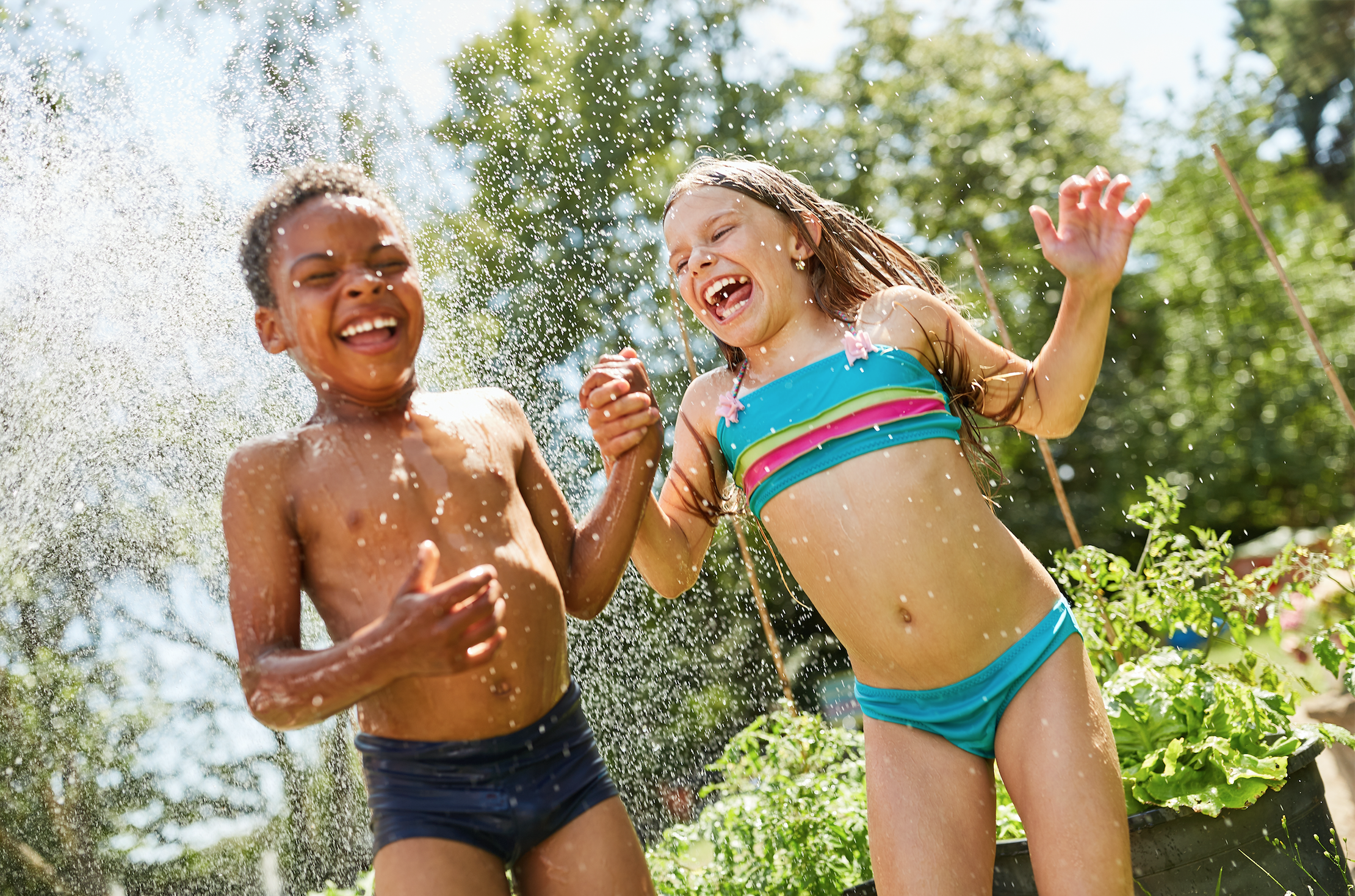 Boy and girl are splashed wet